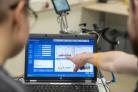 Mensen kijken en wijzen naar het beeldscherm van laptop